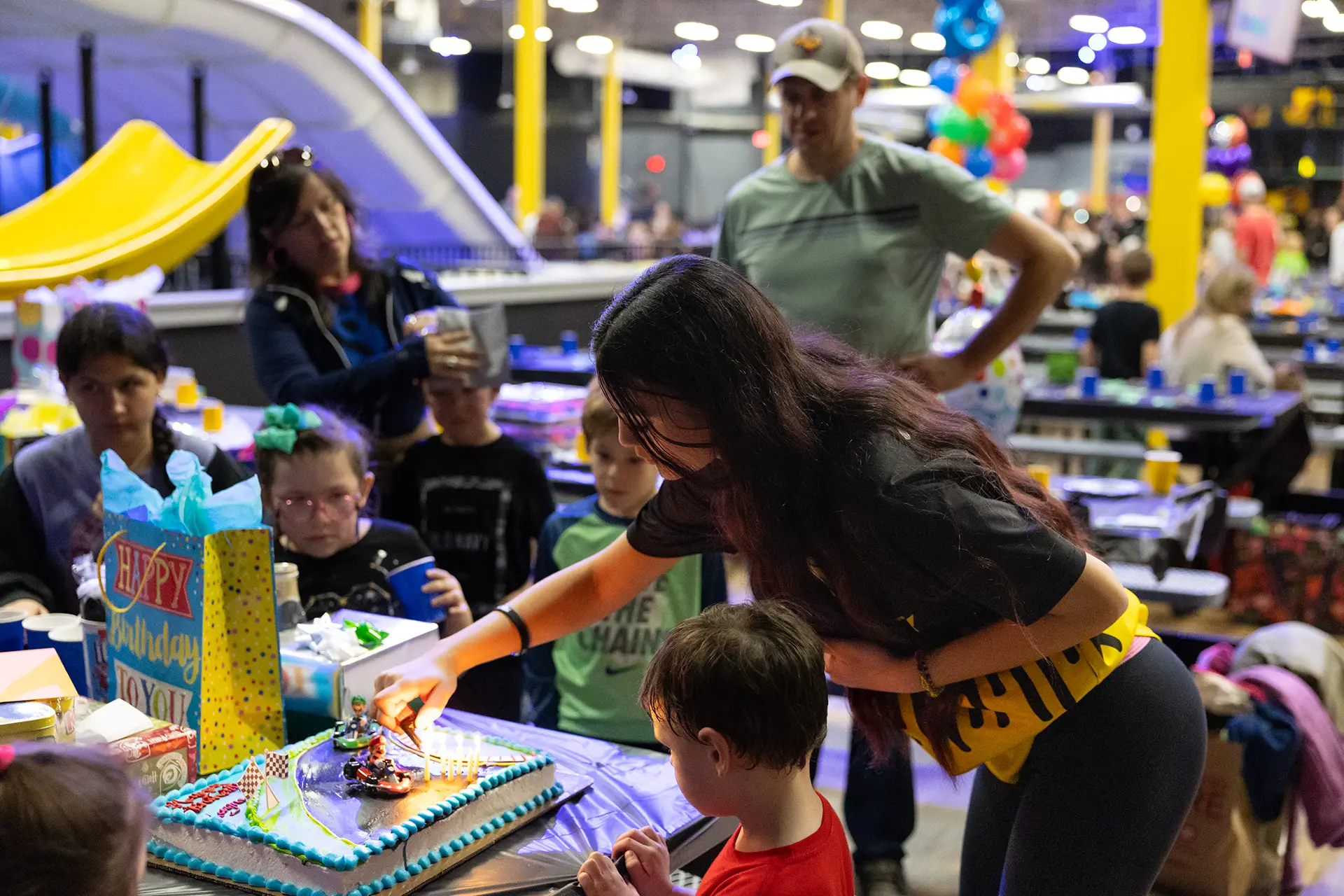 employee helping at birthday party at Slick City Action Park